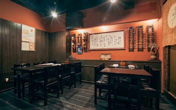 Dining area at Ginza Hanadaikon with traditional decor and seating for a 5/6-course meal.