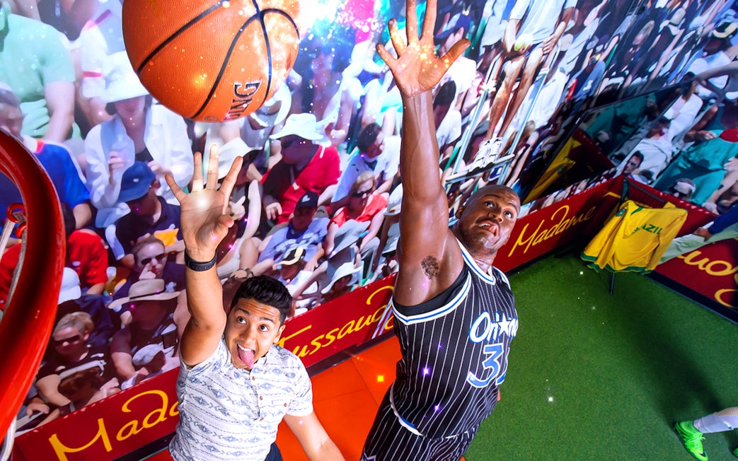 Shaquille O'Neal wax figure in basketball pose at Madame Tussauds Orlando sports exhibit.