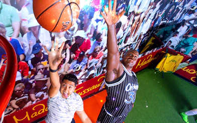 Shaquille O'Neal wax figure in basketball pose at Madame Tussauds Orlando sports exhibit.