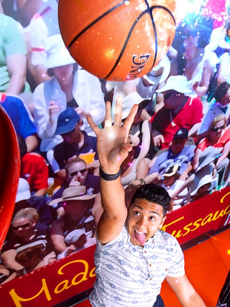 Shaquille O'Neal wax figure in basketball pose at Madame Tussauds Orlando sports exhibit.