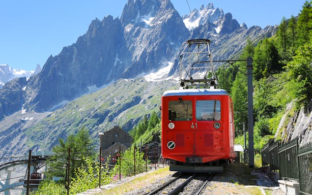 Red train on Mer de Glace route with Mont Blanc in background, Chamonix day trip.