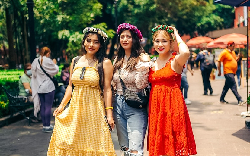 Women wearing floral crowns posing in Coyoacán, Mexico City.