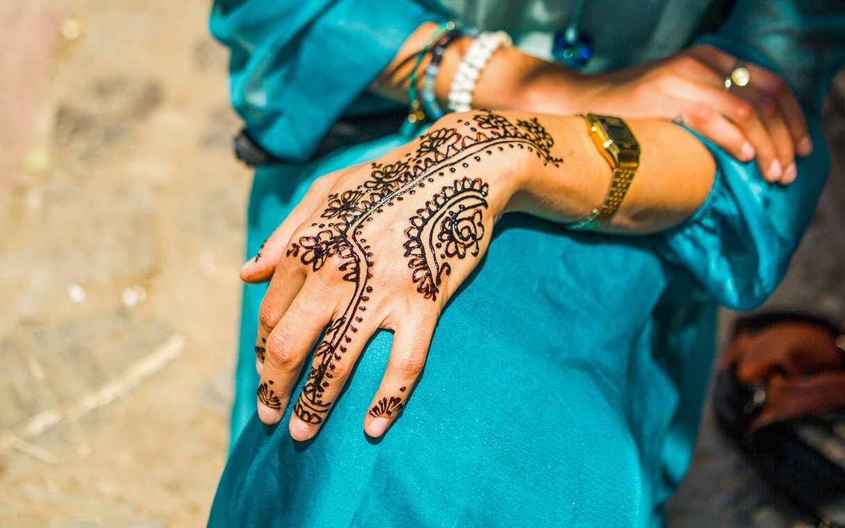Henna design on a hand in Abu Dhabi, part of the Abu Dhabi Saver Pass experience.