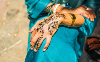 Henna design on a hand in Abu Dhabi, part of the Abu Dhabi Saver Pass experience.