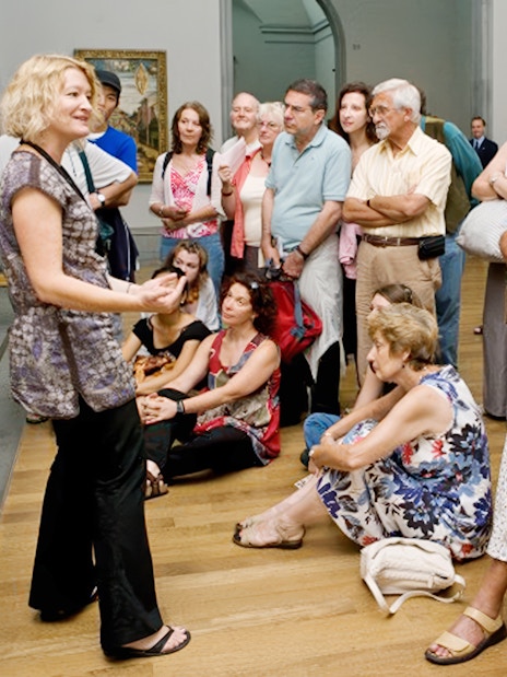 Visitors listening to a guide during a National Gallery tour.