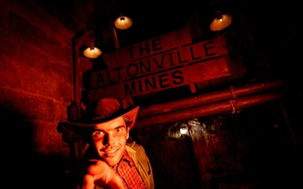 Guide in costume at Altonville Mines during Alton Towers Scarefest.