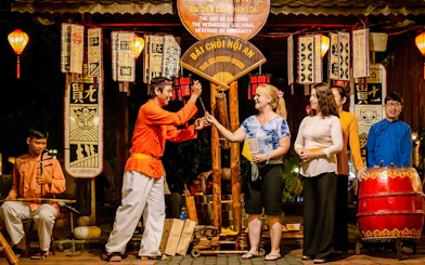 Bai Choi folk game performance in Hoi An with participants and musicians.