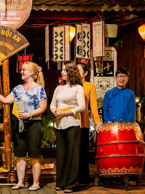 Bai Choi folk game performance in Hoi An with participants and musicians.