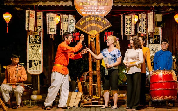 Bai Choi folk game performance in Hoi An with participants and musicians.