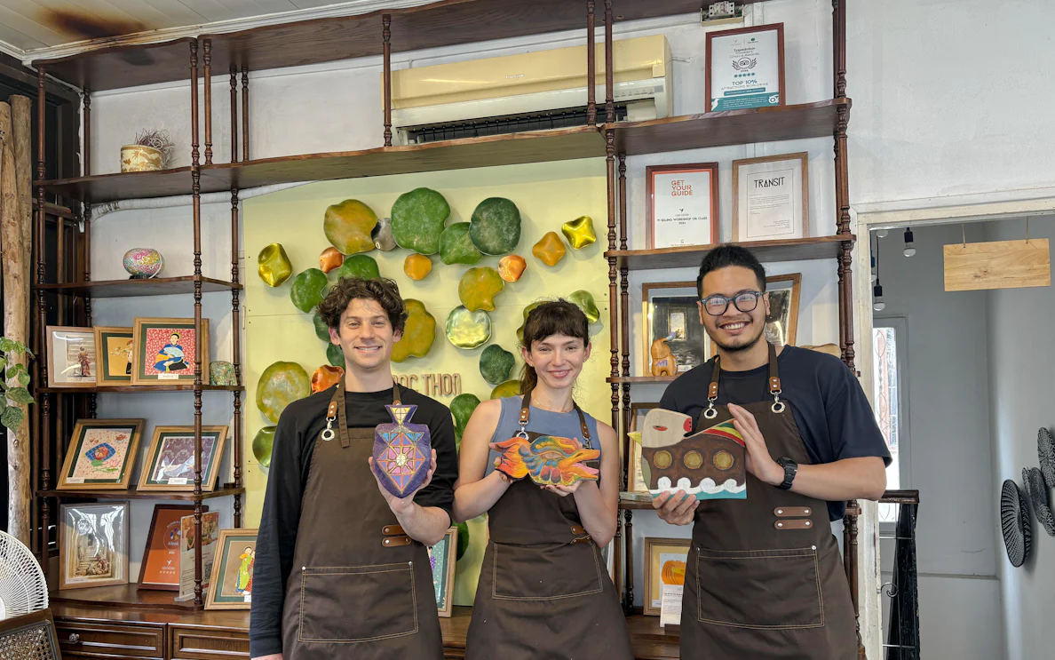 Participants display wooden crafts at Hanoi wood carving workshop.