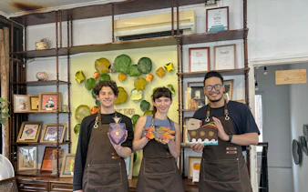 Participants display wooden crafts at Hanoi wood carving workshop.