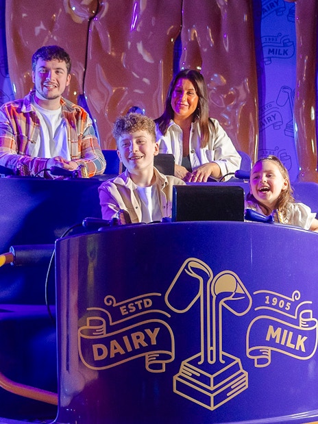 Family enjoying the Cadbury Chocolate Quest ride at Cadbury World.