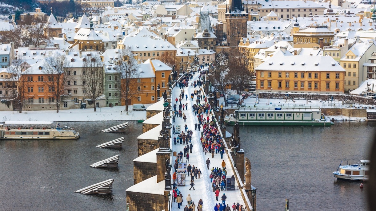 Crowds on Charles Bridge in snowy Prague, February.