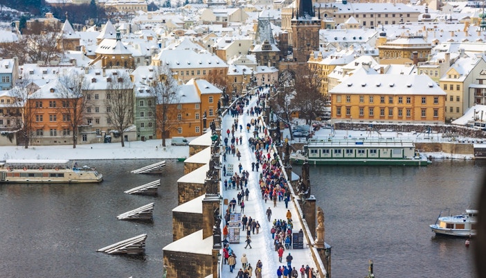 Crowds on Charles Bridge in snowy Prague, February.