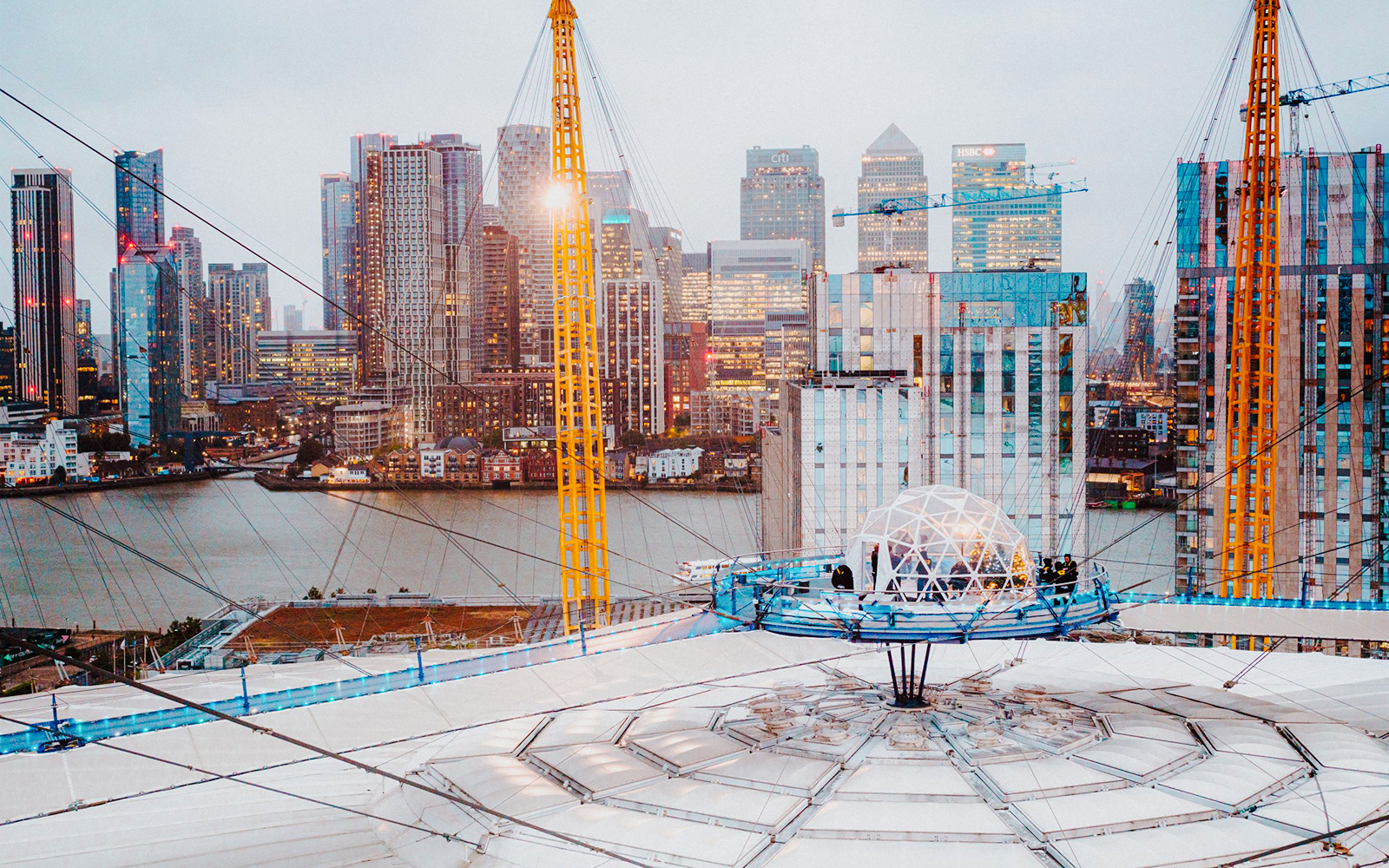 O2 Arena rooftop with snow globe experience overlooking London skyline.