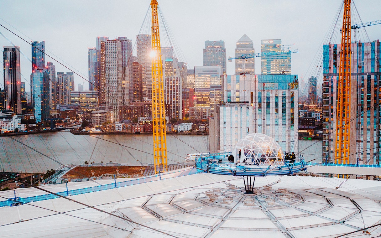 O2 Arena rooftop with snow globe experience overlooking London skyline.