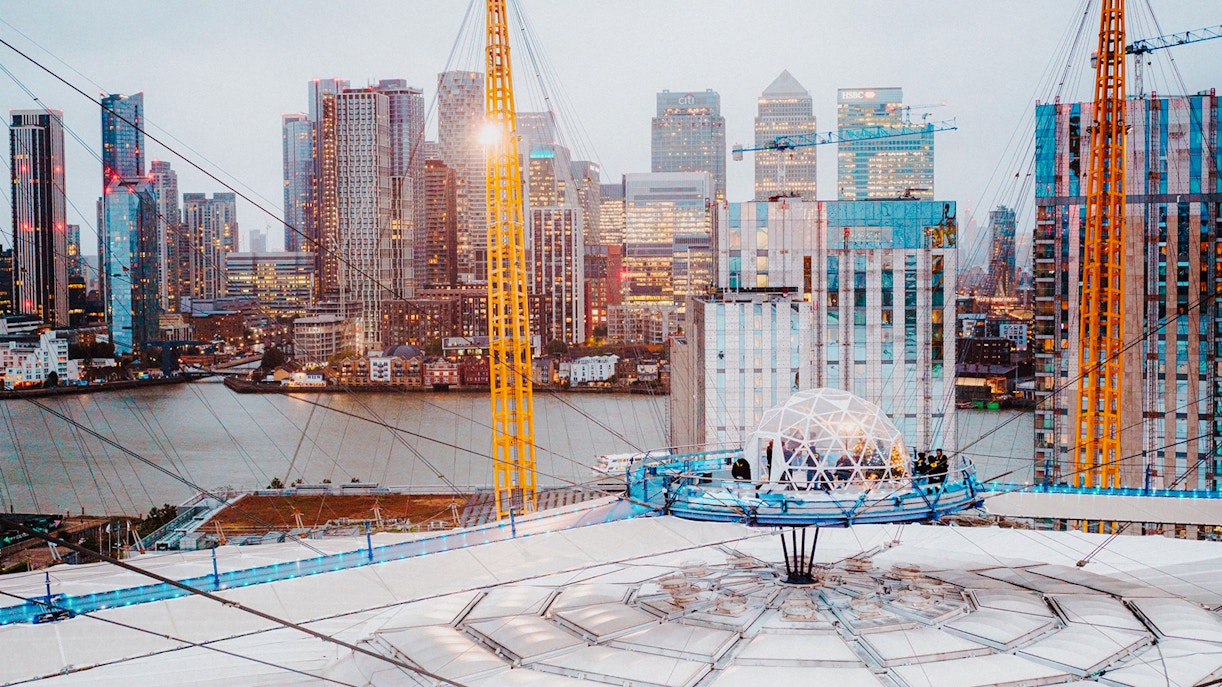 O2 Arena rooftop with snow globe experience overlooking London skyline.