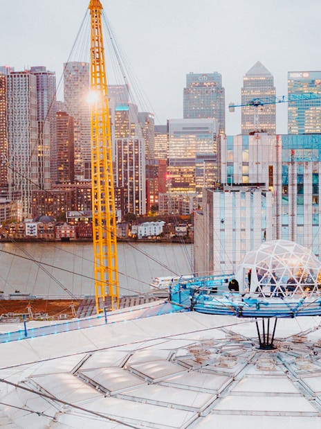 O2 Arena rooftop with snow globe experience overlooking London skyline.