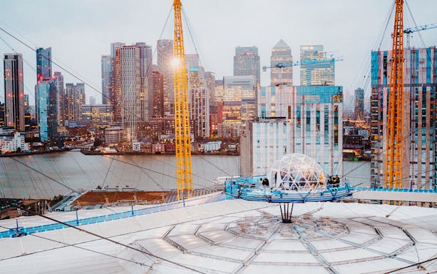 O2 Arena rooftop with snow globe experience overlooking London skyline.