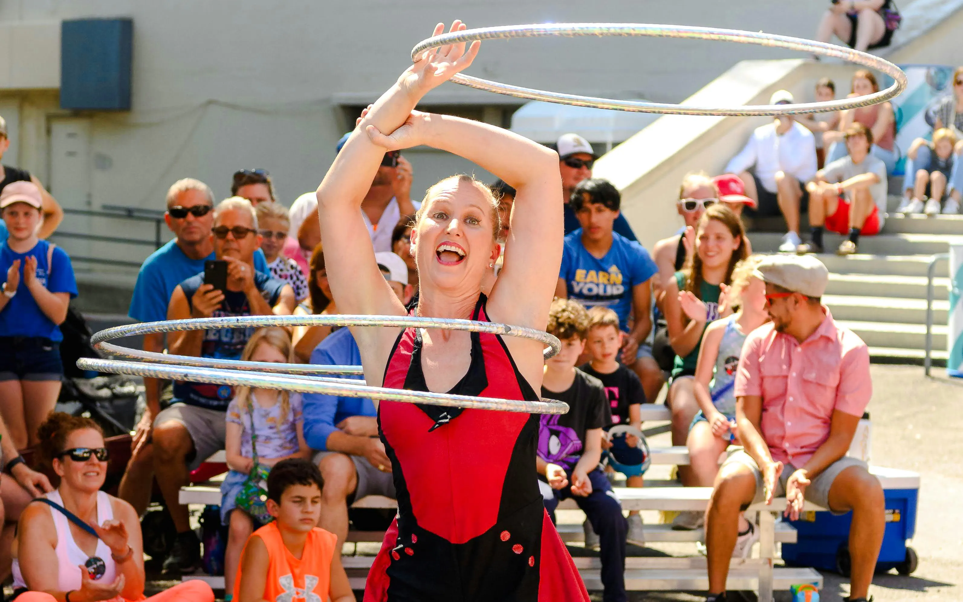 Performer with hula hoops entertaining crowd at State Fair of Texas.