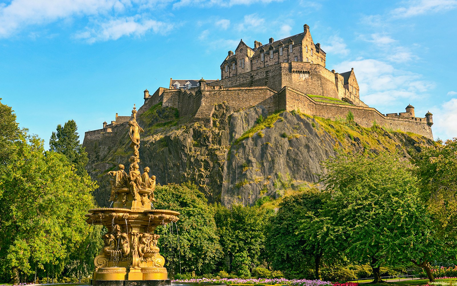 Edinburgh Castle atop Castle Rock with Ross Fountain in foreground on The Royal Edinburgh Tour.