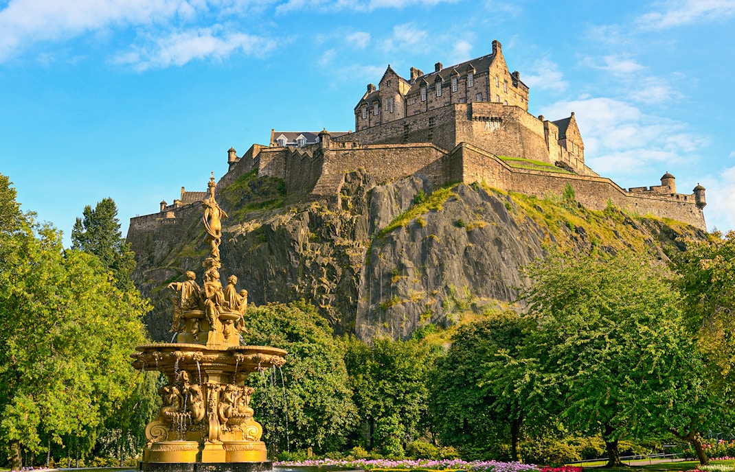Edinburgh Castle atop Castle Rock with Ross Fountain in foreground on The Royal Edinburgh Tour.