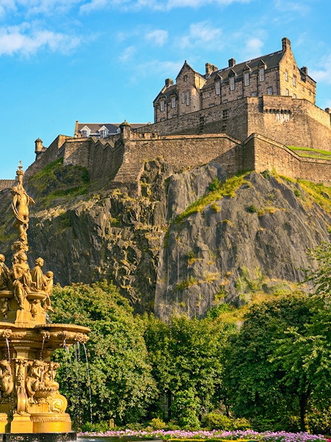Edinburgh Castle atop Castle Rock with Ross Fountain in foreground on The Royal Edinburgh Tour.