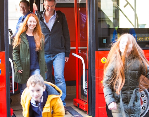 A father with his daughter on a hop on hop off bus enjoying views on the way, while clicking photos