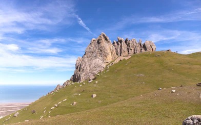 Five Fingers Mountain rock formation with grassy hillside, Baku, Azerbaijan.