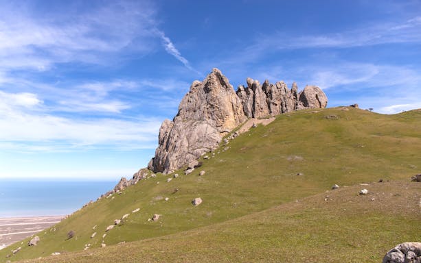 Five Fingers Mountain rock formation with grassy hillside, Baku, Azerbaijan.