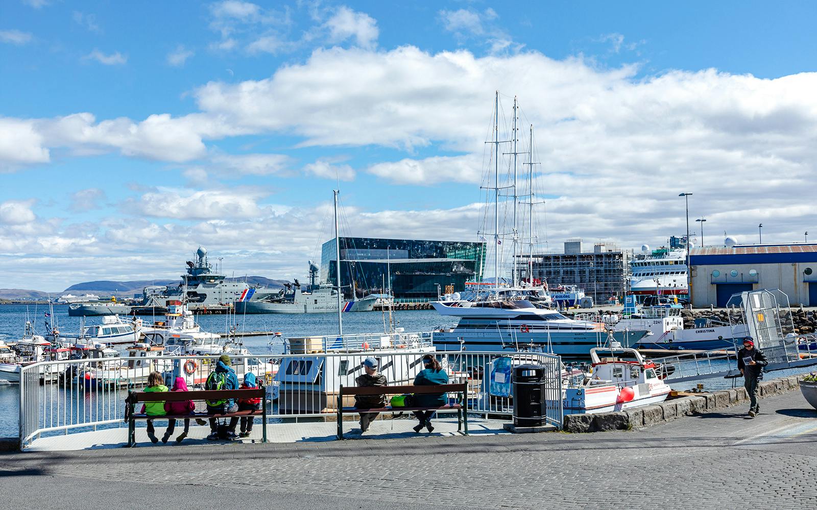 Reykjavik’s Old Harbour with boats and Harpa Concert Hall in the background.
