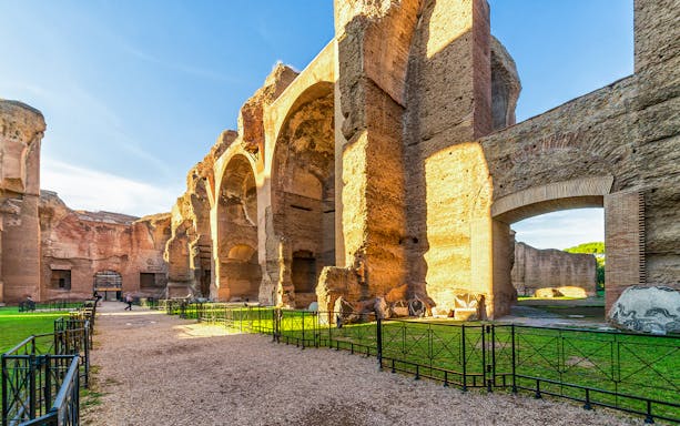 Ancient Roman ruins with arches and pathways, part of the Catacombs Tour Package.
