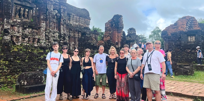 Tourists exploring ancient ruins at Mỹ Sơn Sanctuary, Vietnam.