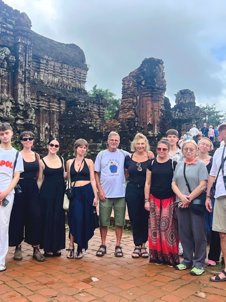 Tourists exploring ancient ruins at Mỹ Sơn Sanctuary, Vietnam.