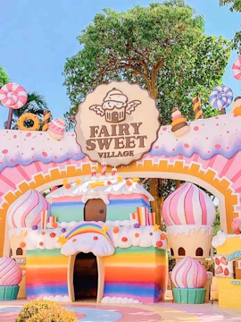 Colorful candy-themed entrance at Fairy Sweet Village with cupcake decorations.