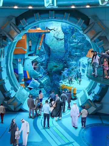 Visitors exploring underwater exhibits at Sea World Abu Dhabi.