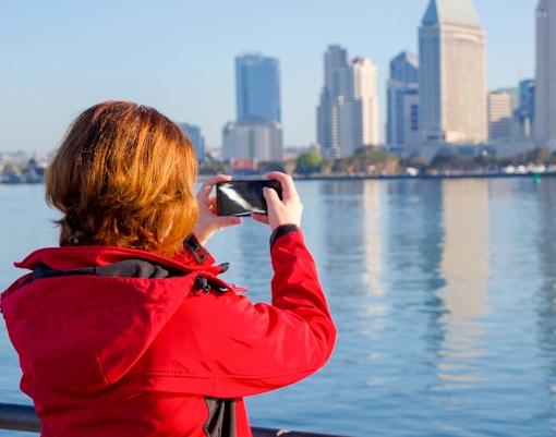 Young woman photographing with smartphone.