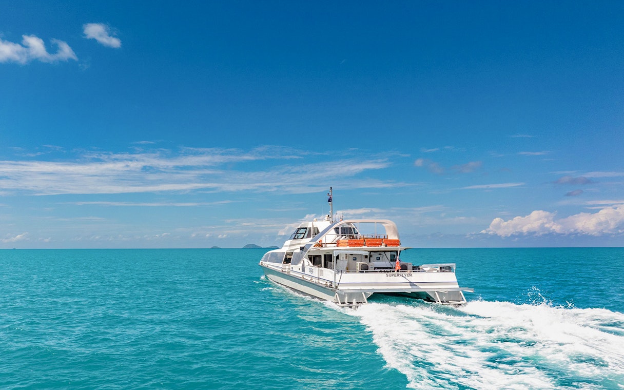 Catamaran cruising on clear blue waters during ZigZag Whitsundays Day Tour.