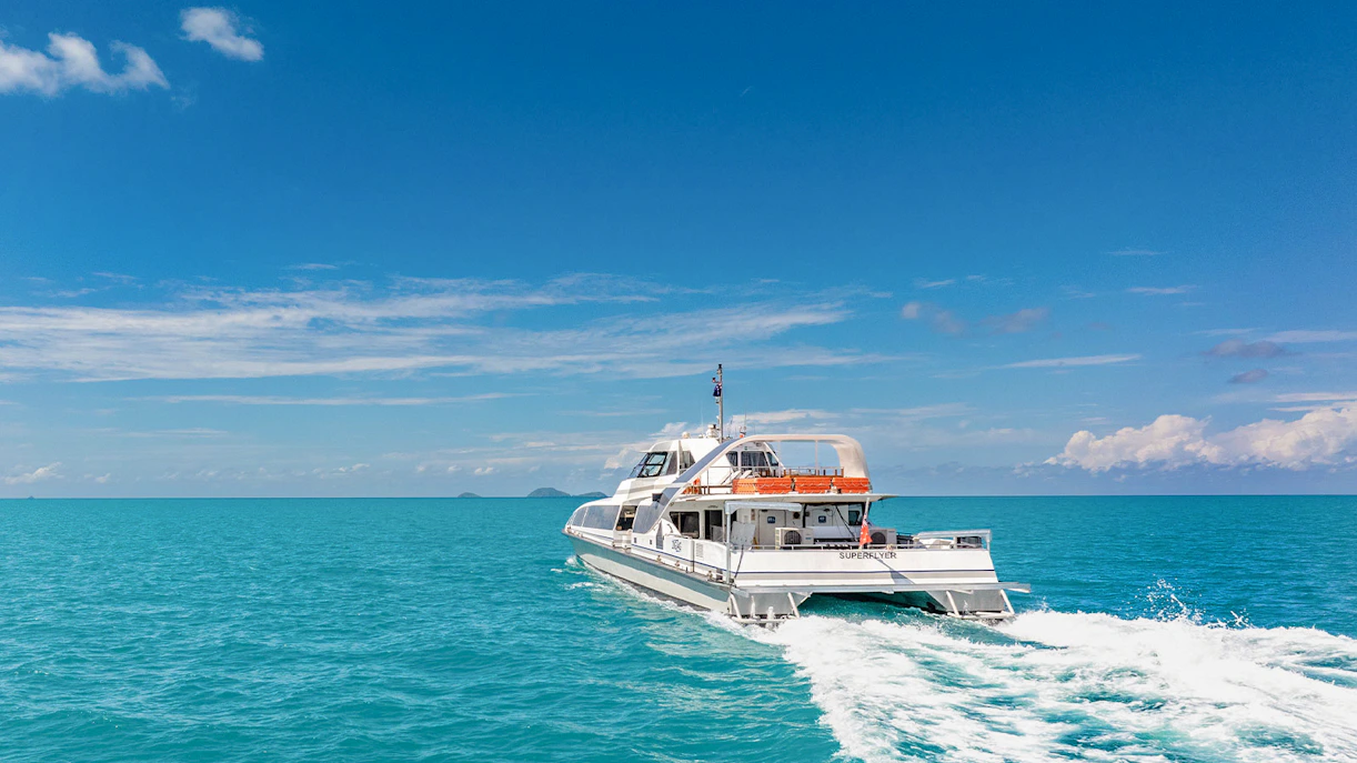 Catamaran cruising on clear blue waters during ZigZag Whitsundays Day Tour.