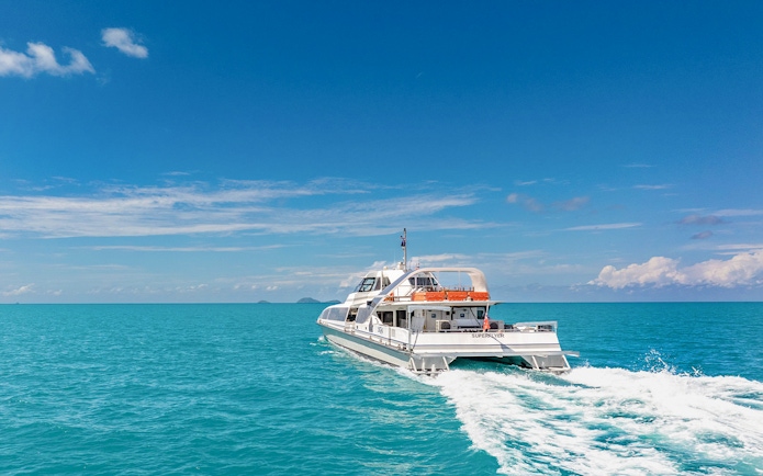Catamaran cruising on clear blue waters during ZigZag Whitsundays Day Tour.