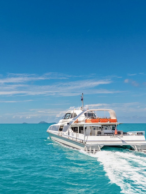 Catamaran cruising on clear blue waters during ZigZag Whitsundays Day Tour.