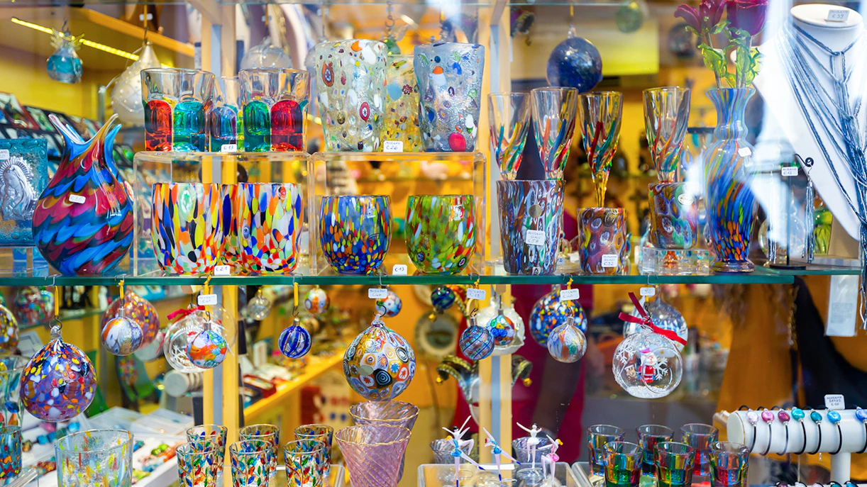 Colorful Murano glass souvenirs in a Venetian shop display.