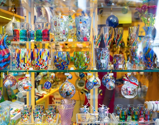 Murano glass artifacts displayed in a museum setting.