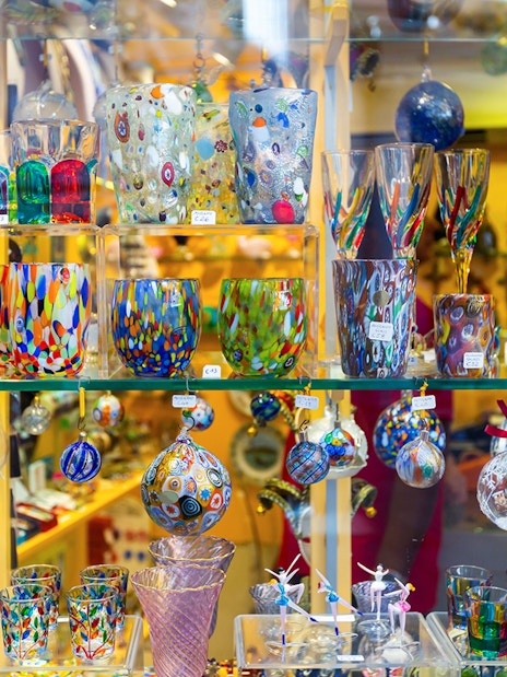 Colorful Murano glass souvenirs in a Venetian shop display.