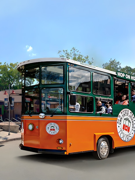 Old Town Trolley near San Antonio Zoo with passengers on board.