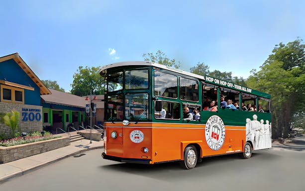 Old Town Trolley near San Antonio Zoo with passengers on board.
