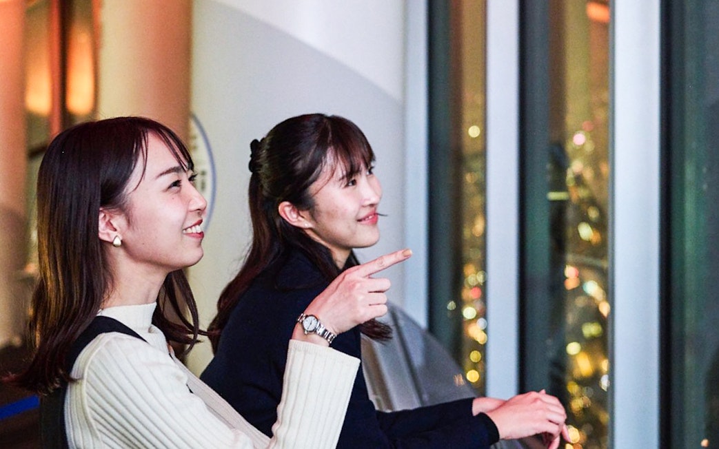 Tourists enjoying Tokyo night skyline from Tembo Deck.