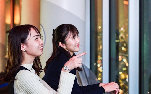 Tourists enjoying Tokyo night skyline from Tembo Deck.