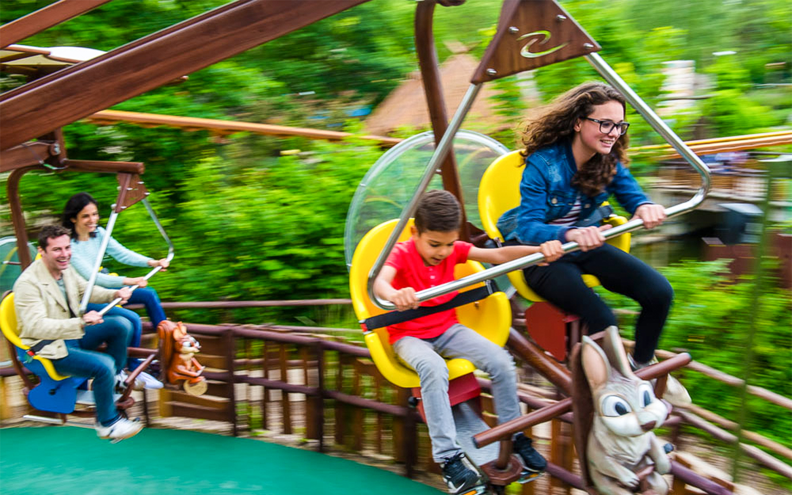Visitors enjoying a roller coaster ride at Parc Asterix, France.