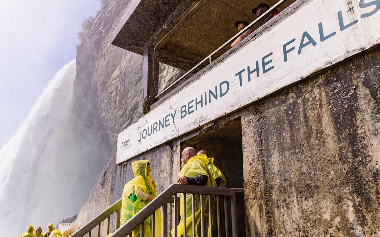 People in yellow ponchos at Journey Behind the Falls, Niagara Falls.